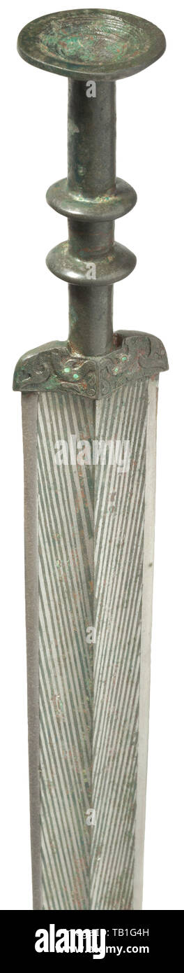 A Chinese bronze sword, Warring States period, Double-edged blade of white bronze with double fullers on both sides and medial ridge, the surface with herringbone pattern inlaid in yellow bronze, the blade mounting decorated in fine relief and set with eight small turquoises, the grip segmented by two girdles, disk-shaped pommel adorned with ornamental pattern in relief. Fine patina. Length 52 cm. Cf. C.H. Wang Collection, Shang and Zhou Chinese Bronze Weaponry, Taiwan, 1983. Provenance: Hermann Historica, auction 46, lot 767. China, Chinese, his, Additional-Rights-Clearance-Info-Not-Available Stock Photo