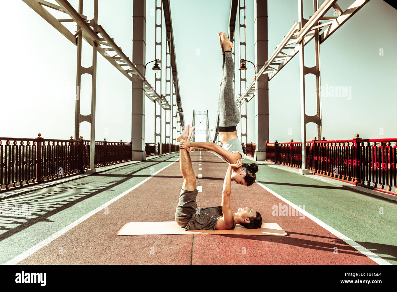Sporty fit couple doing a candlestick yoga pose Stock Photo Alamy