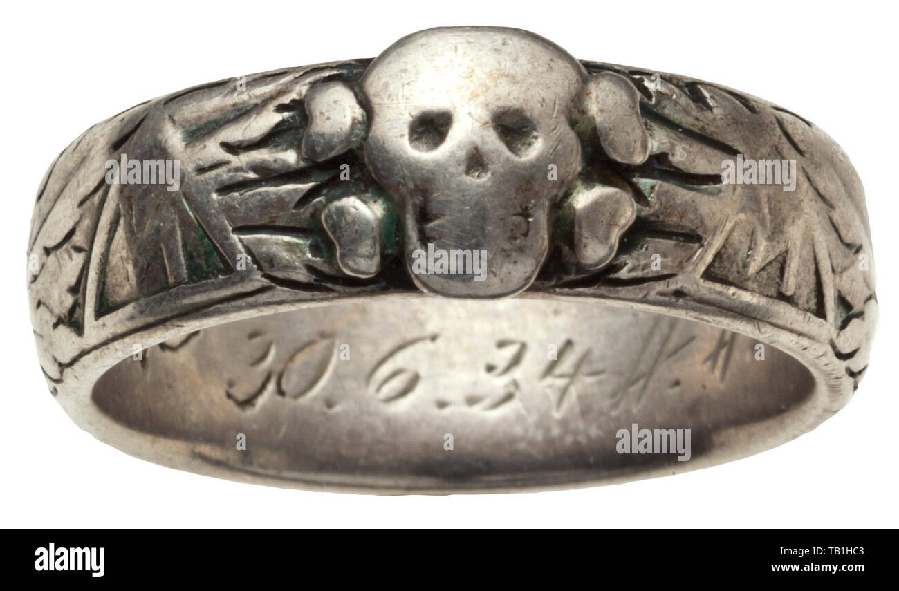 Sturmbannführer Alfred Suhr - an SS death's head ring 1934, Custom-made by the jeweller Gahr in Munich, soldered underneath the separately applied death's head, dedication 'S.lb. Suhr 30.6.34 H.Himmler' engraved on the inside. The outside heavily rubbed in places. Weight 8.8 g. Comes with a silver cigarette case ('900' and 'MZ'), the interior gold-plated, inscription (tr.) ''never relent' - your leaders and comrades in the SS Sturmbann II/42 - Christmas 1934' engraved on the inside of the lid, dimensions 9.5 x 7.7 cm, weight 134 g, as well as a copy of 'Mein Kampf' 1930 wit, Editorial-Use-Only Stock Photo