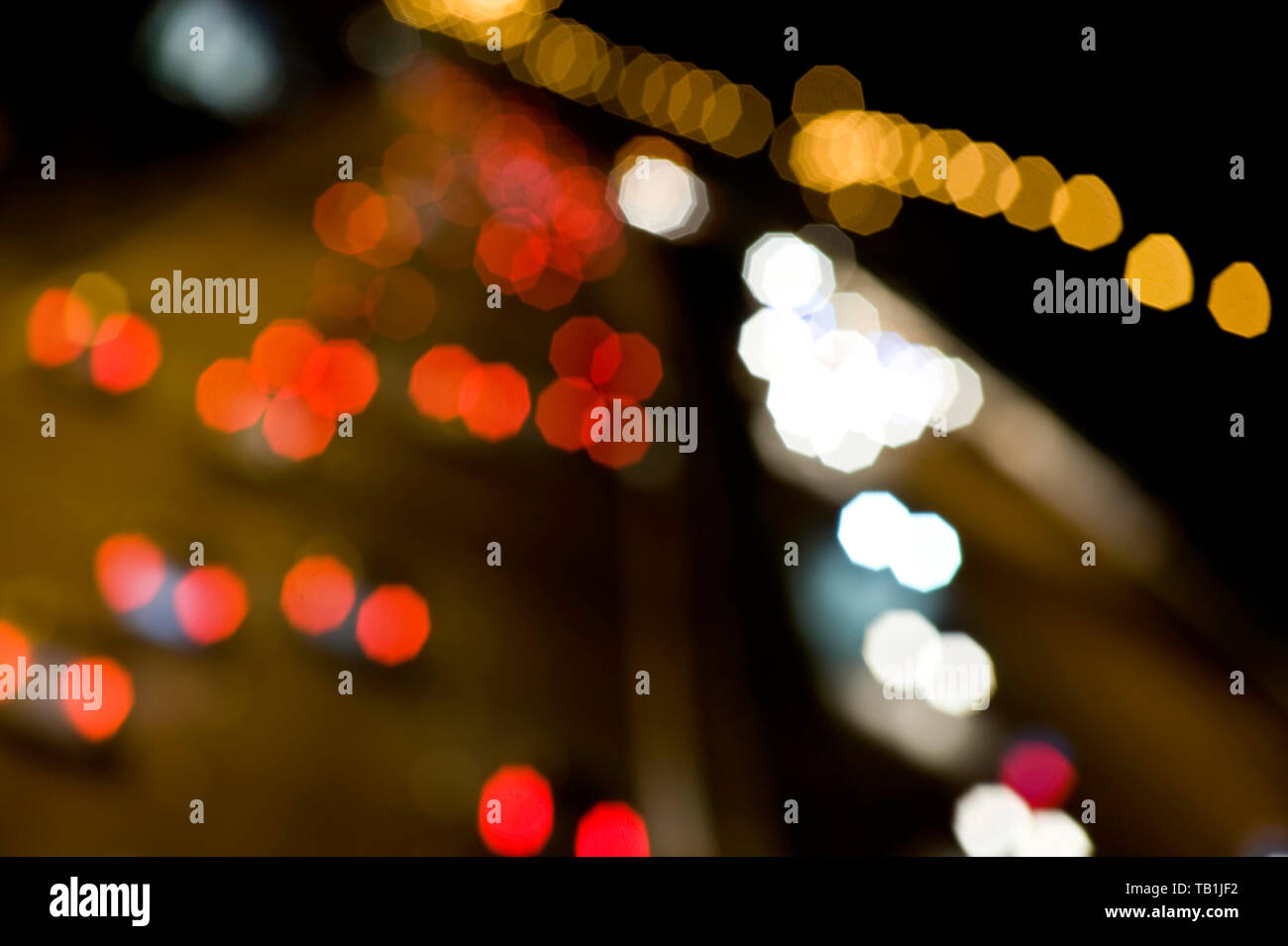 Blurred head and tail lights of cars speeding past on the motorway at