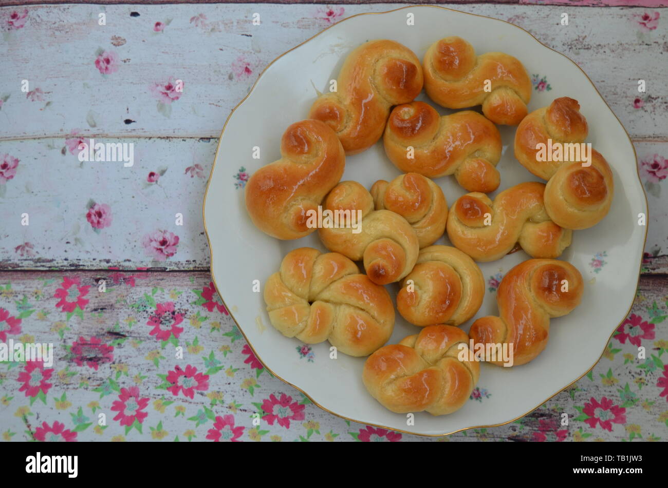 Home made traditional czech easter sweet yeast dough pastry with honey glaze: Jidase or Jidasky (Judas Knots).  They are traditionally baked and eaten Stock Photo