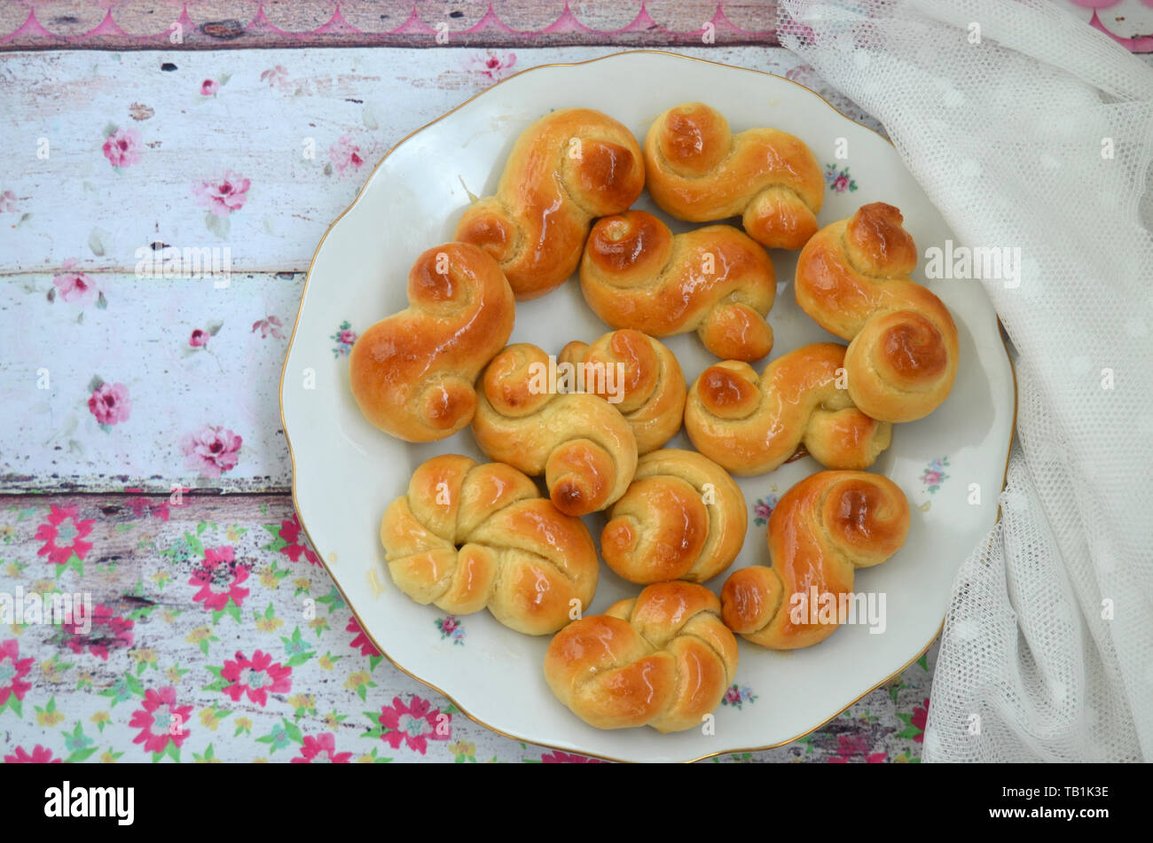 Home made traditional czech easter sweet yeast dough pastry with honey glaze: Jidase or Jidasky (Judas Knots).  They are traditionally baked and eaten Stock Photo