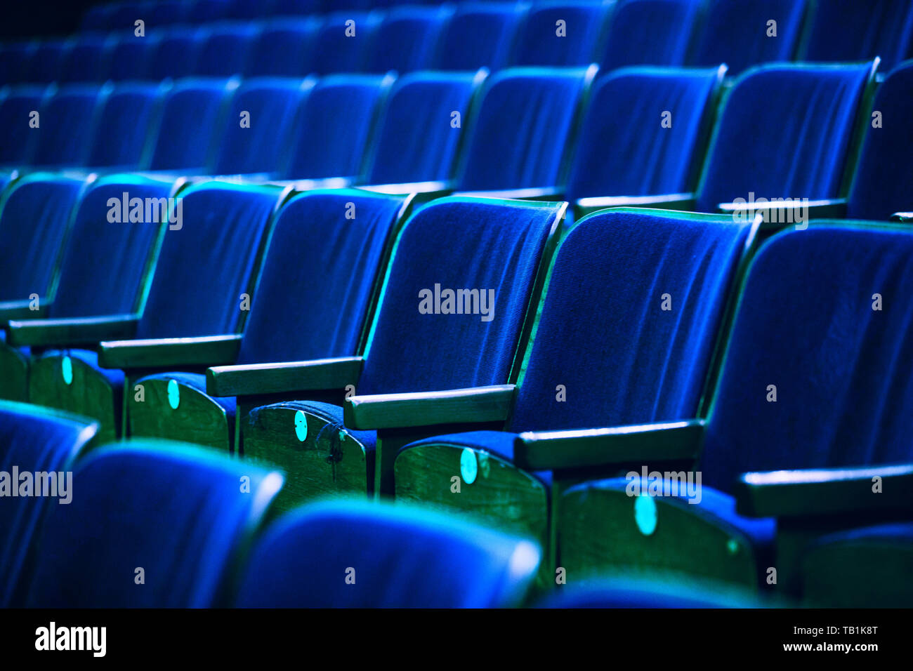 auditorium with seats, chairs in auditorium colored by spotlights Stock Photo Alamy