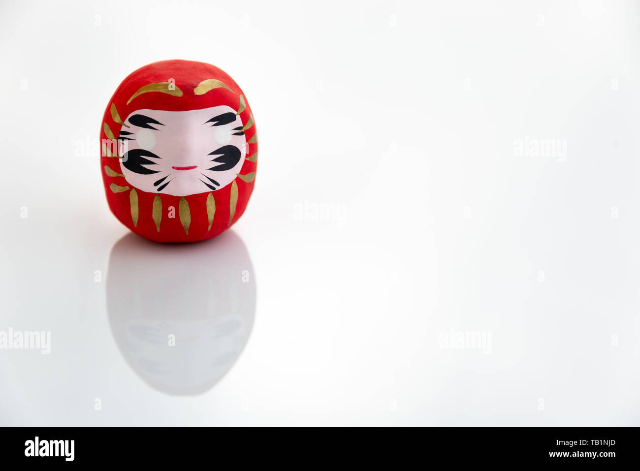 Traditional japanese Daruma doll symbol of fortune and luck isolated in white background Stock Photo