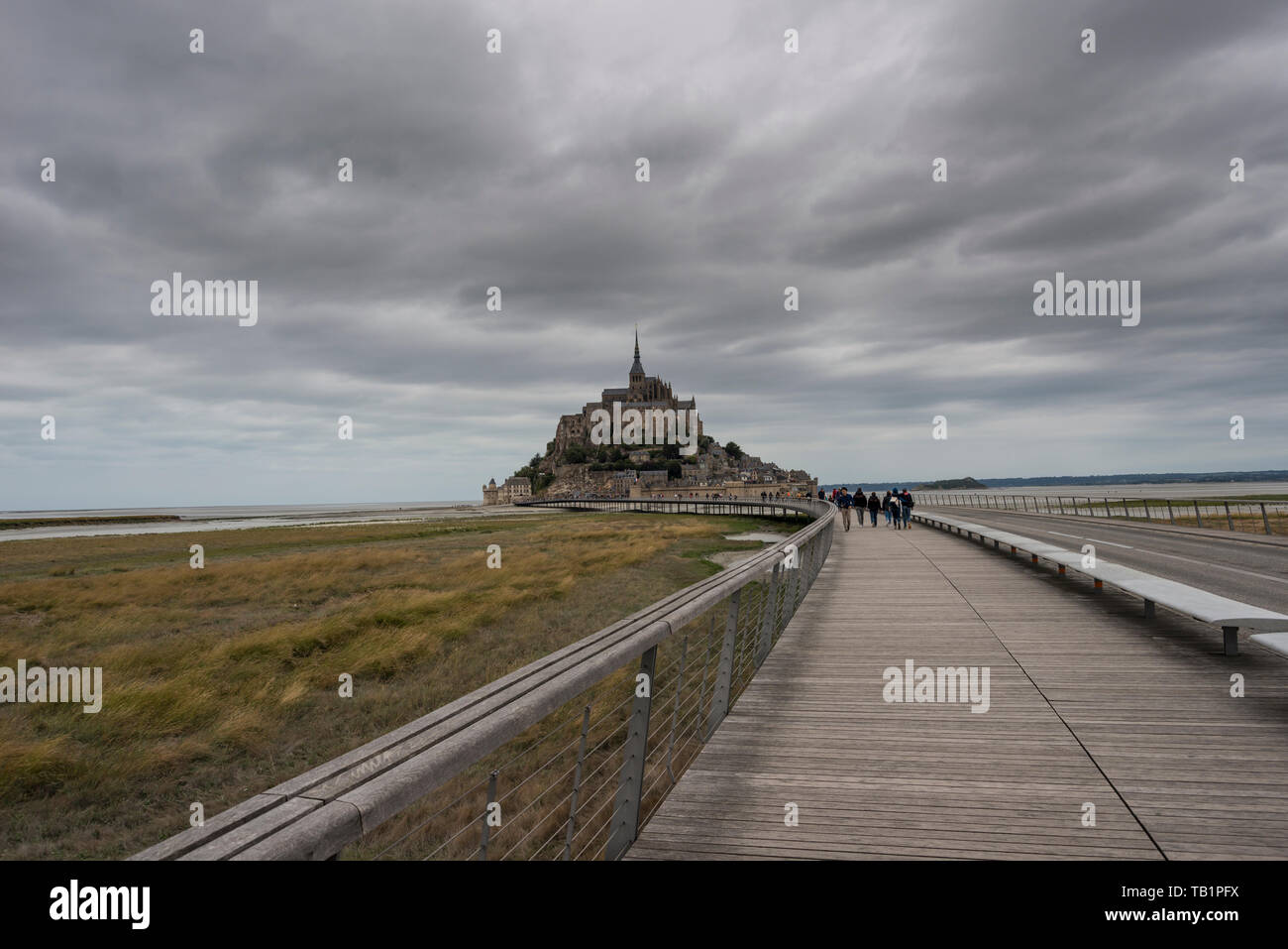 Tourists walking to and from Le Mont Saint Michel, over newly built