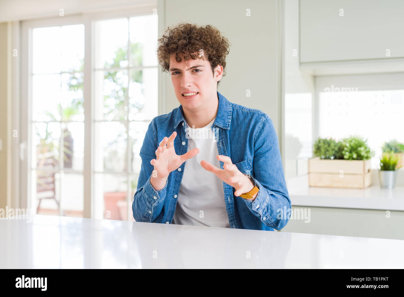 Young handsome man wearing casual denim jacket at home disgusted ...