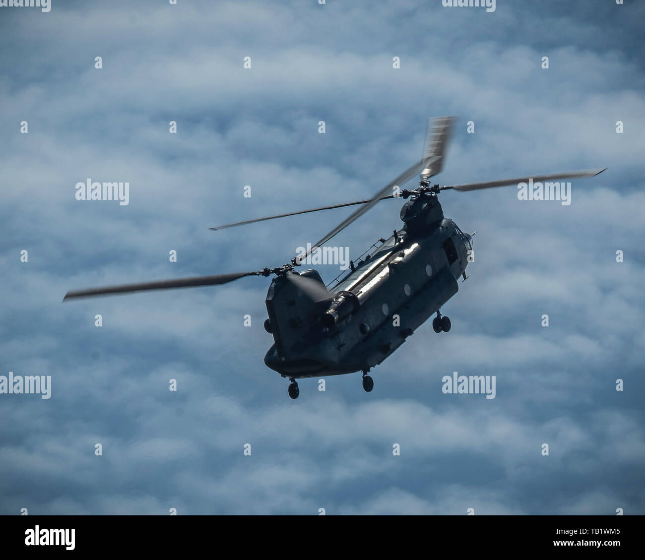 RAF Chinook Helicopter with blurred blades and a cloudy sky Stock Photo