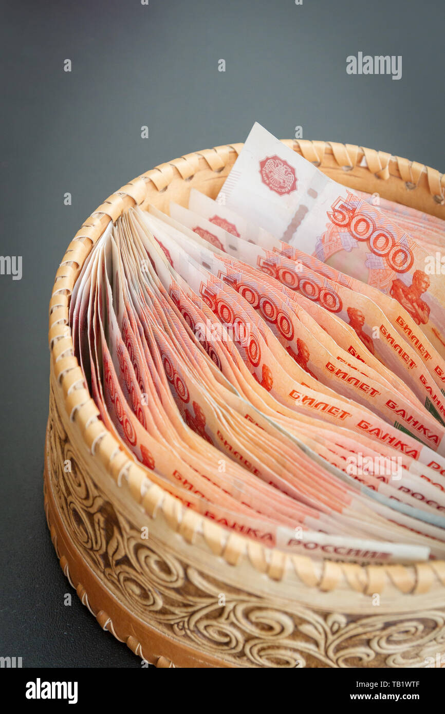 Rubbles R Round A lot of banknotes worth five thousand rubles are in a round wooden ...