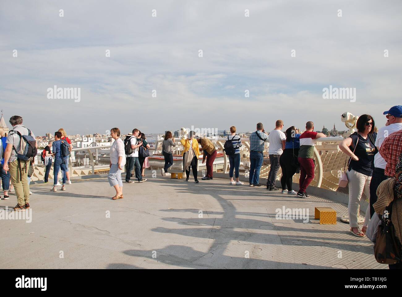 People stand on the viewing platform on the roof of the Metropol Parasol in Seville, Spain on April 2, 2019. Stock Photo