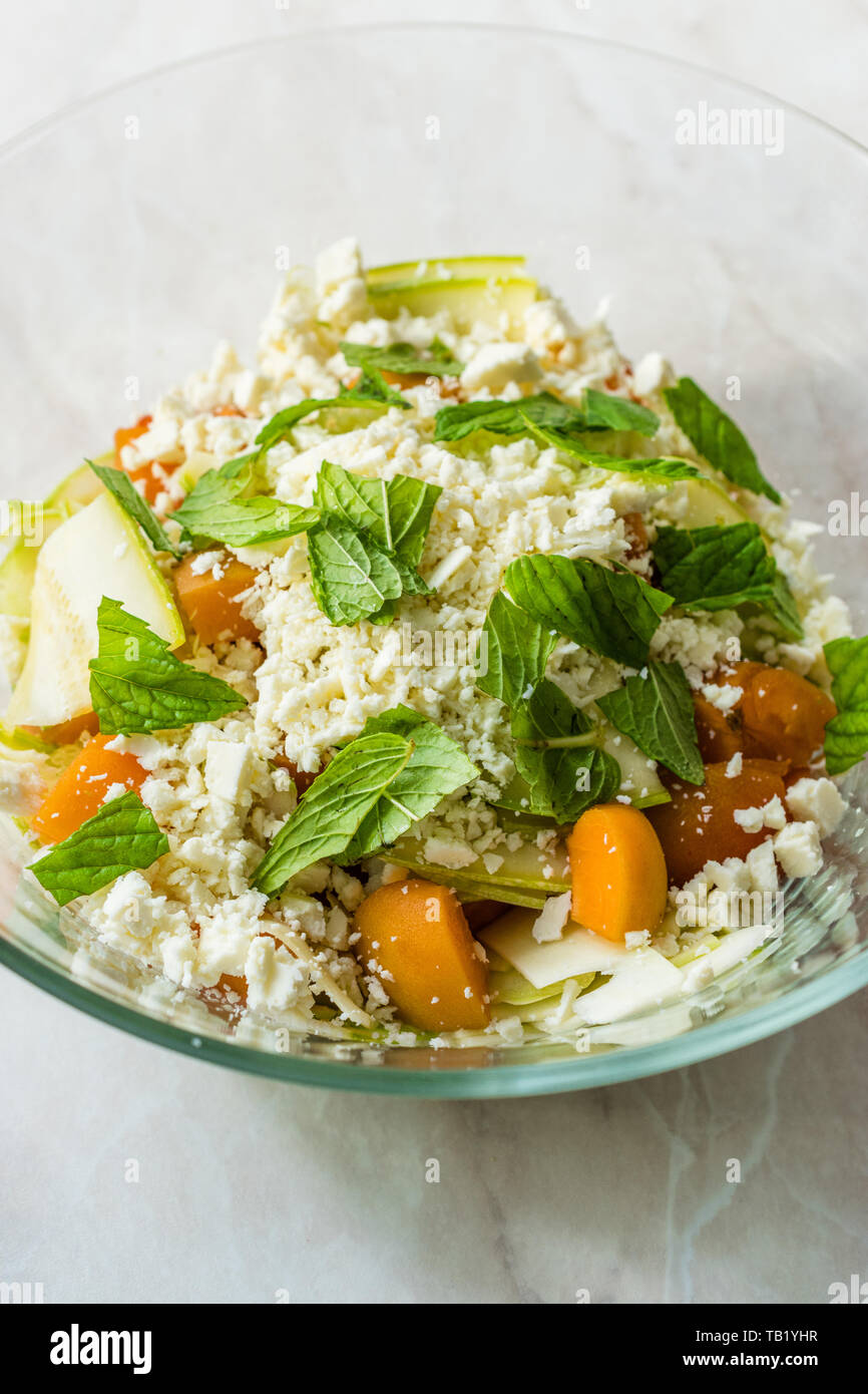 Zucchini and Apricot Salad with Cheese and Mint Leaves Ready to Mix