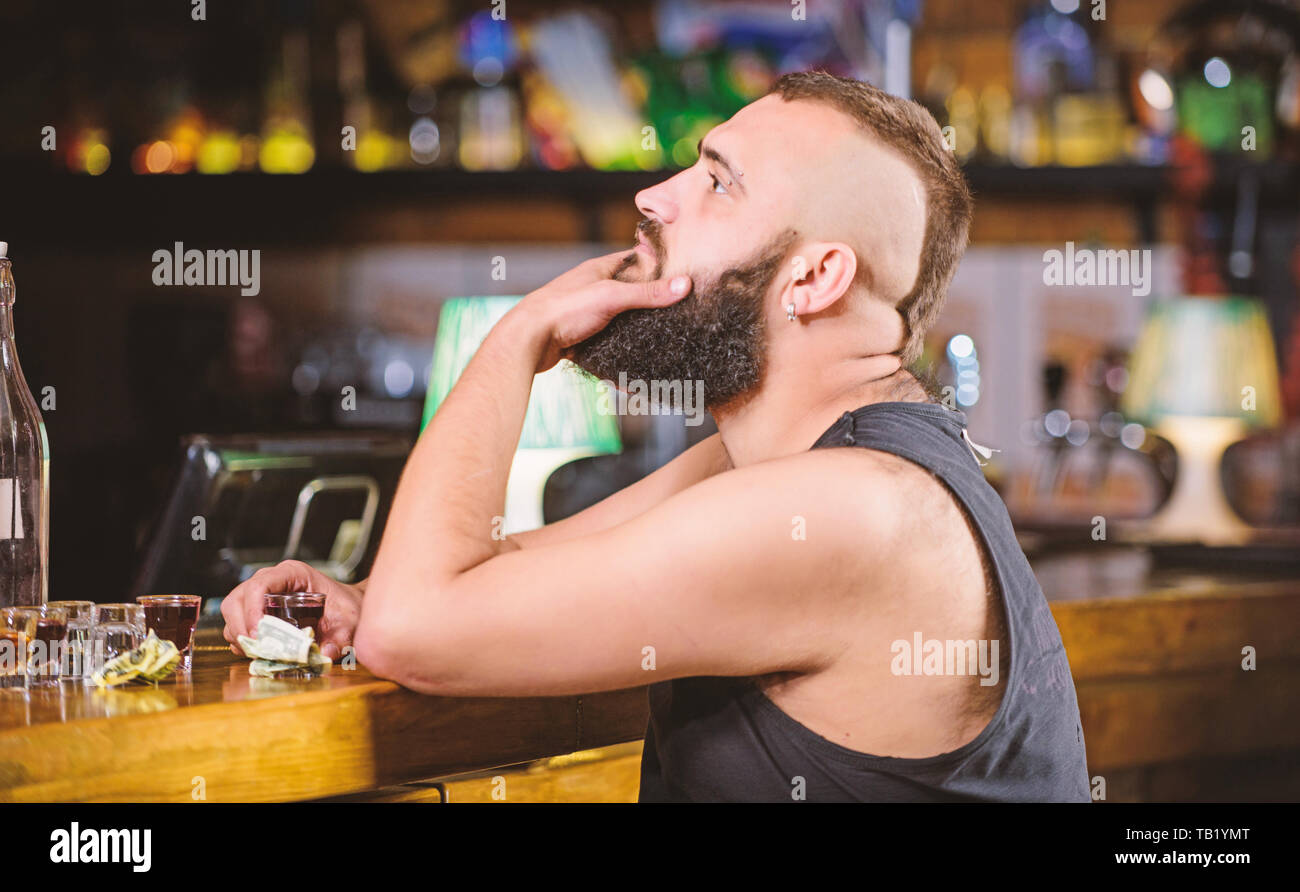 Man drunk sit alone in pub. Alcoholism and depression. Alcohol addicted