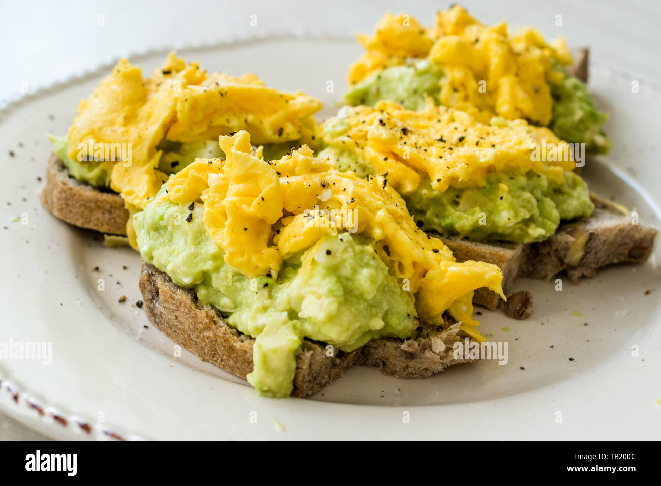 Scrambled Eggs With Avocado On Toast Bread For Breakfast Organic Food Stock Photo Alamy