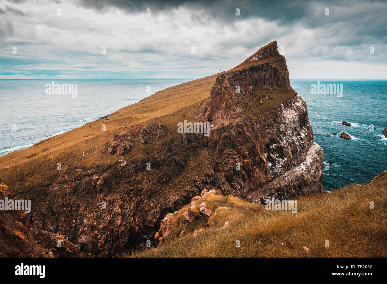 View of the cliffs and the village on the island of Mykines, Faroe. Stock Photo