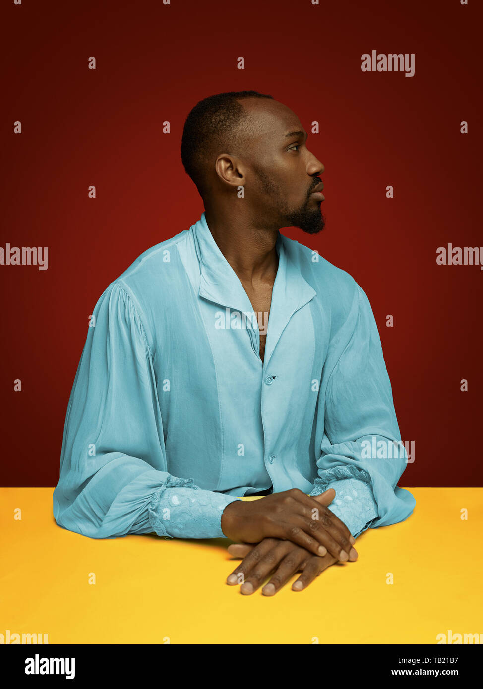Grandee Young man as a medieval grandee or nobleman on red studio background ...