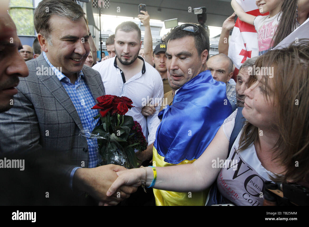 May 29, 2019 - Kiev, Ukraine - Former Georgian president and ex-Odessa Governor MIKHEIL SAAKASHVILI (L) greets his supporters, as he arrives to the Boryspil international airport near Kiev, Ukraine, on 29 May 2019. Saakashvili returned to Ukraine after Ukrainian President Volodymyr Zelensky has reinstated Mikheil Saakashvili's Ukrainian citizenship on 28 May 2019. Zelensky deleted the respective provision from his predecessor Petro Poroshenko's No. 196 order dated July 26, 2017, the UNIAN inform agency reported. Ukrainian opposition leader Mikheil Saakashvili was deported to Poland on 12 Febru Stock Photo