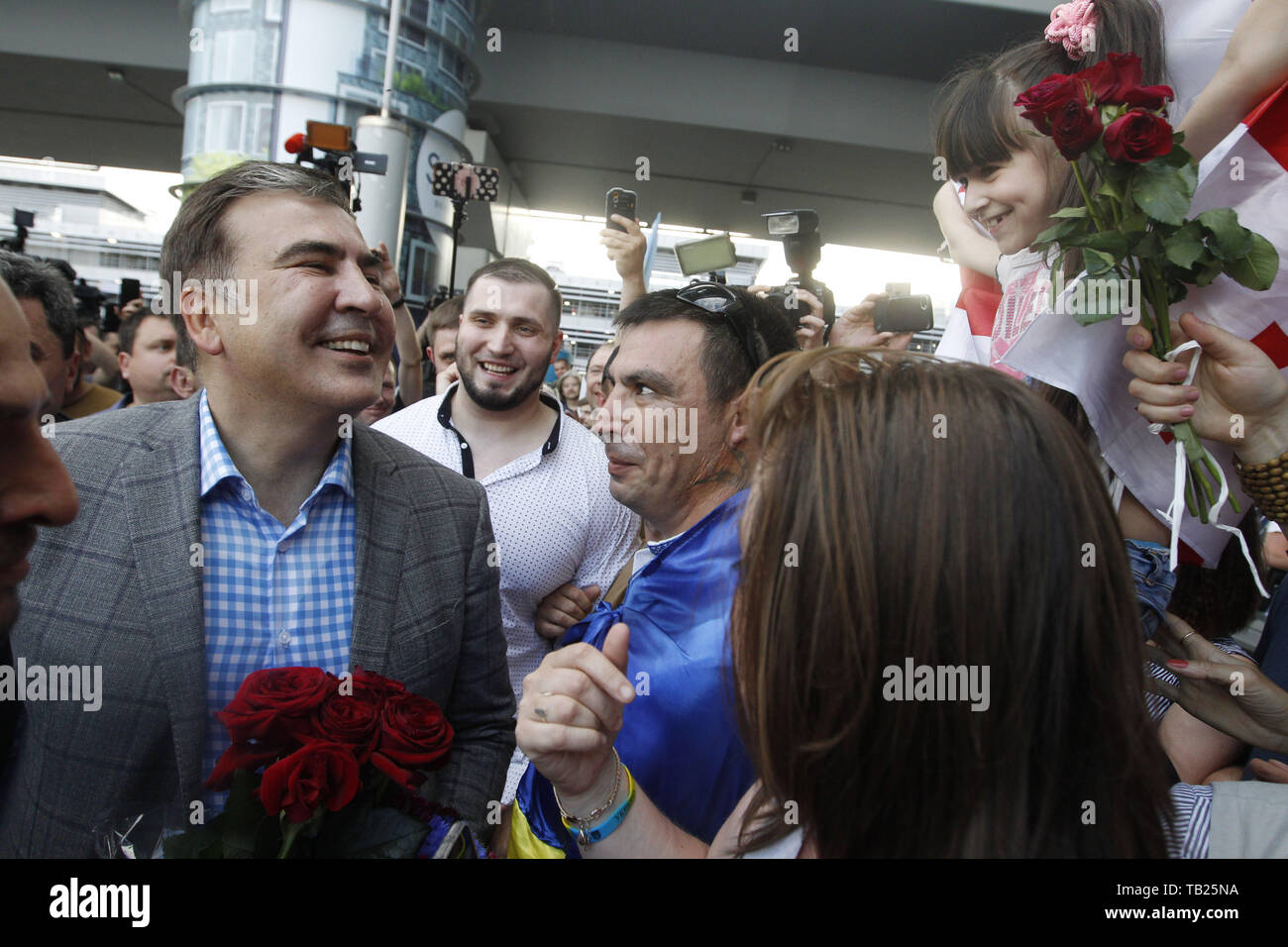 May 29, 2019 - Kiev, Ukraine - Former Georgian president and ex-Odessa Governor MIKHEIL SAAKASHVILI (L) speaks with supporters as he arrives to the Boryspil international airport near Kiev, Ukraine, on 29 May 2019. Saakashvili returned to Ukraine after Ukrainian President Volodymyr Zelensky has reinstated Mikheil Saakashvili's Ukrainian citizenship on 28 May 2019. Zelensky deleted the respective provision from his predecessor Petro Poroshenko's No. 196 order dated July 26, 2017, the UNIAN inform agency reported. Ukrainian opposition leader Mikheil Saakashvili was deported to Poland on 12 Febru Stock Photo