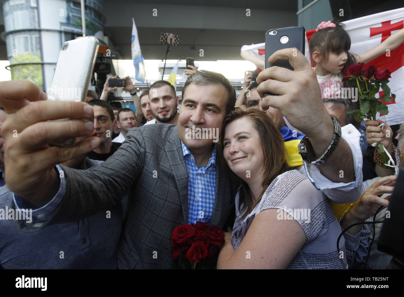 May 29, 2019 - Kiev, Ukraine - Former Georgian president and ex-Odessa Governor MIKHEIL SAAKASHVILI (C) takes a selfie with a supporter, as he arrives to the Boryspil international airport near Kiev, Ukraine, on 29 May 2019. Saakashvili returned to Ukraine after Ukrainian President Volodymyr Zelensky has reinstated Mikheil Saakashvili's Ukrainian citizenship on 28 May 2019. Zelensky deleted the respective provision from his predecessor Petro Poroshenko's No. 196 order dated July 26, 2017, the UNIAN inform agency reported. Ukrainian opposition leader Mikheil Saakashvili was deported to Poland o Stock Photo