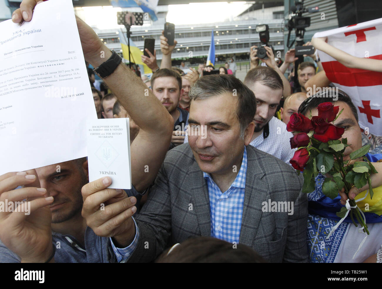 May 29, 2019 - Kiev, Ukraine - Former Georgian president and ex-Odessa Governor MIKHEIL SAAKASHVILI shows Certificate for returns to Ukraine and Presidential decree of about the return of his citizenship of Ukraine, as he arrives to the Boryspil international airport near Kiev, Ukraine, on 29 May 2019. Saakashvili returned to Ukraine after Ukrainian President Volodymyr Zelensky has reinstated Mikheil Saakashvili's Ukrainian citizenship on 28 May 2019. Zelensky deleted the respective provision from his predecessor Petro Poroshenko's No. 196 order dated July 26, 2017, the UNIAN inform agency rep Stock Photo