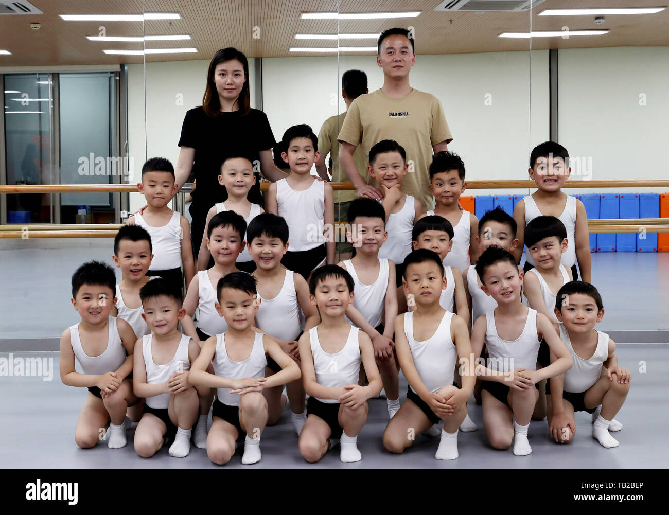 Shanghai, China. 22nd May, 2019. Boy ballet dancers pose for photos with teachers at the art school Shanghai Little Star in Shanghai, east China, May 22, 2019. The Shanghai Little Star, a subsidiary of the SMG (Shanghai Media Group), opened its first boy ballet class in 2018. After one year of training, more than 20 boys between the ages of four and six, have gone through a series of tough exercises and become little ballet fans. Credit: Liu Ying/Xinhua/Alamy Live News Stock Photo