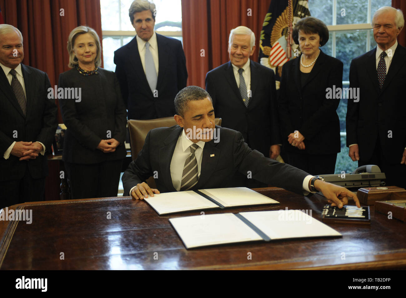 Washington, District of Columbia, USA. 2nd Feb, 2011. United States President Barack Obama signs the New START Treaty during a ceremony in the Oval Office of the White House, with, from left, U.S. Secretary of Defense Robert Gates, U.S. Secretary of State Hillary Rodham Clinton, U.S. Senator John Kerry (Democrat of Massachusetts), U.S. Senator Richard Lugar (Republican of Indiana), U.S. Senator Dianne Feinstein (Democrat of California), U.S. Senator Thad Cochran (Republican of Mississippi. Credit: Leslie E. Kossoff/Pool via CNP Credit: Leslie E. Kossoff/CNP/ZUMA Wire/Alamy Live News Stock Photo