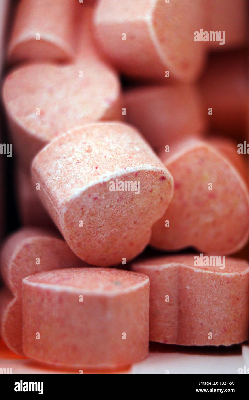 Pile of pink heart shape sugar candies, concept Stock Photo