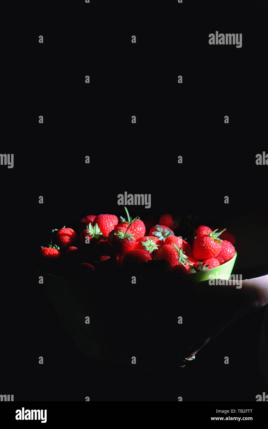 Juicy Sweet Strawberries Bucket on black background Stock Photo - Alamy