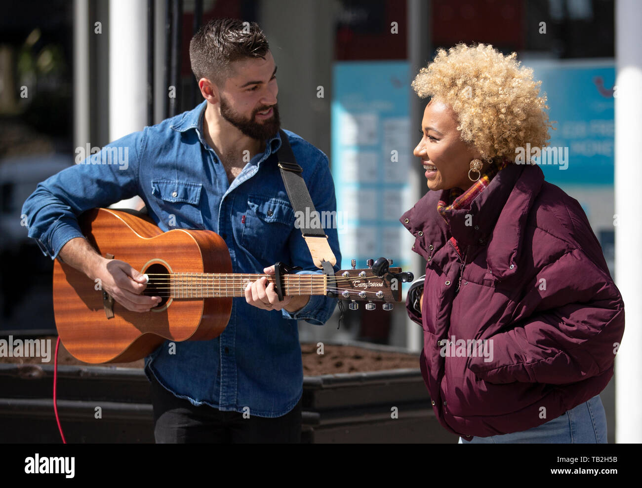Singer-songwriter Emeli Sande with busking musician Finn Henderson Palmer during filming in her home city of Aberdeen for a new BBC Scotland series 'Emeli Sande's Street Symphony'. Stock Photo