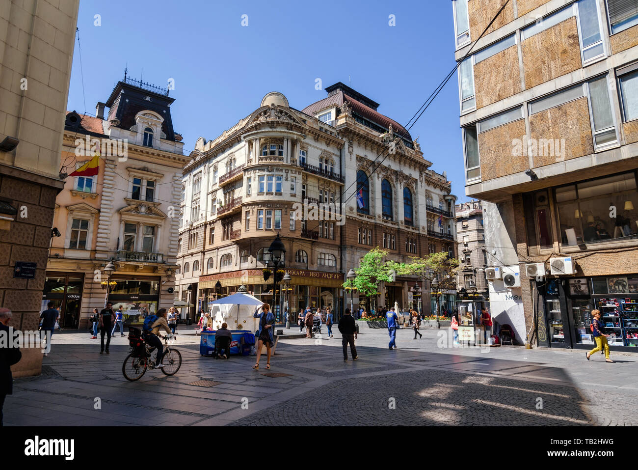 Belgrade, Serbia. April 19, 2018. People walking in Knez Mihailova street. City scene and old town with building facades, green trees, tourists and sp Stock Photo