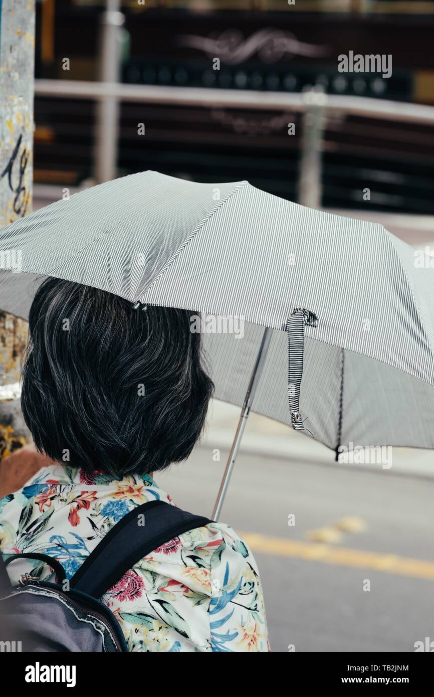 A female with a backpack and an umbrella Stock Photo Alamy