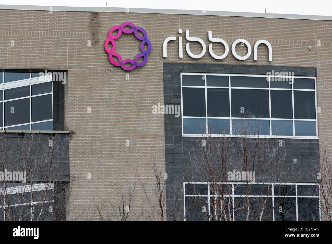 A logo sign outside of a facility occupied by Ribbon Communications in ...