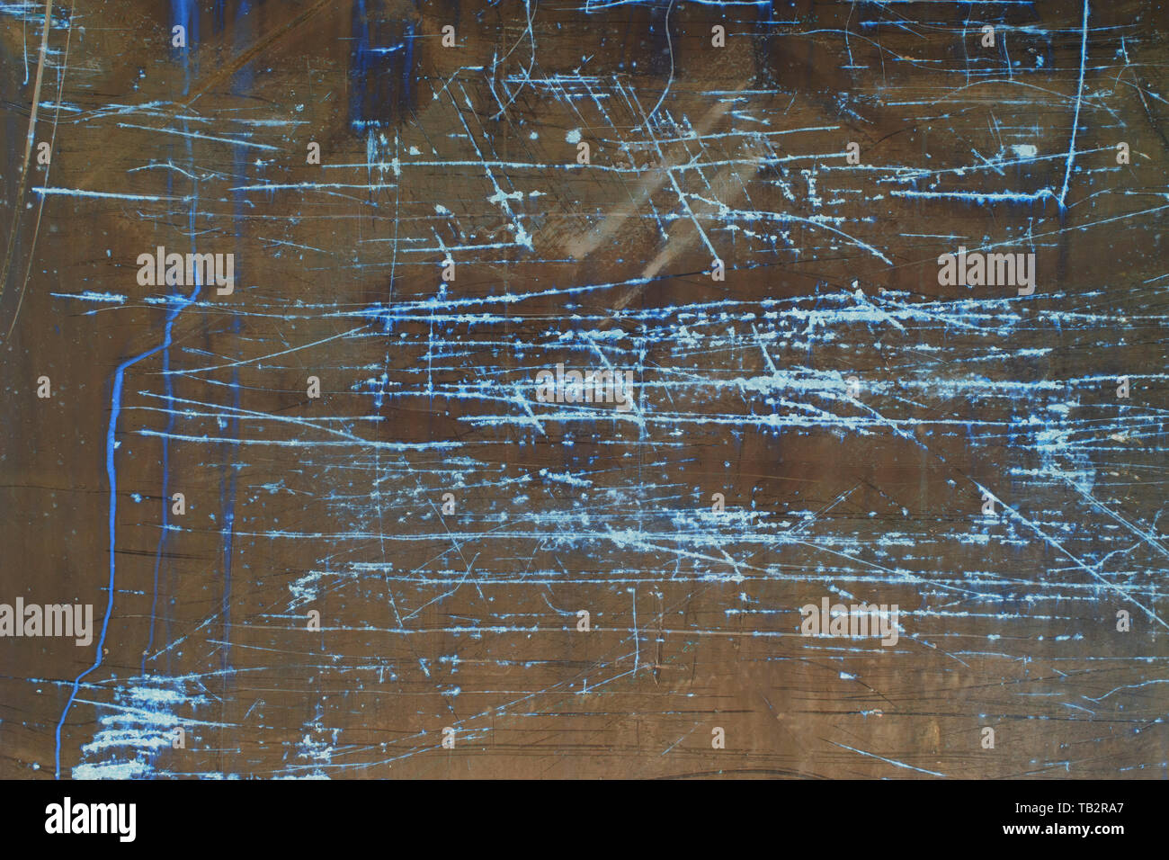 Inverted image of scratch marks and peeling paint on metal wall Stock