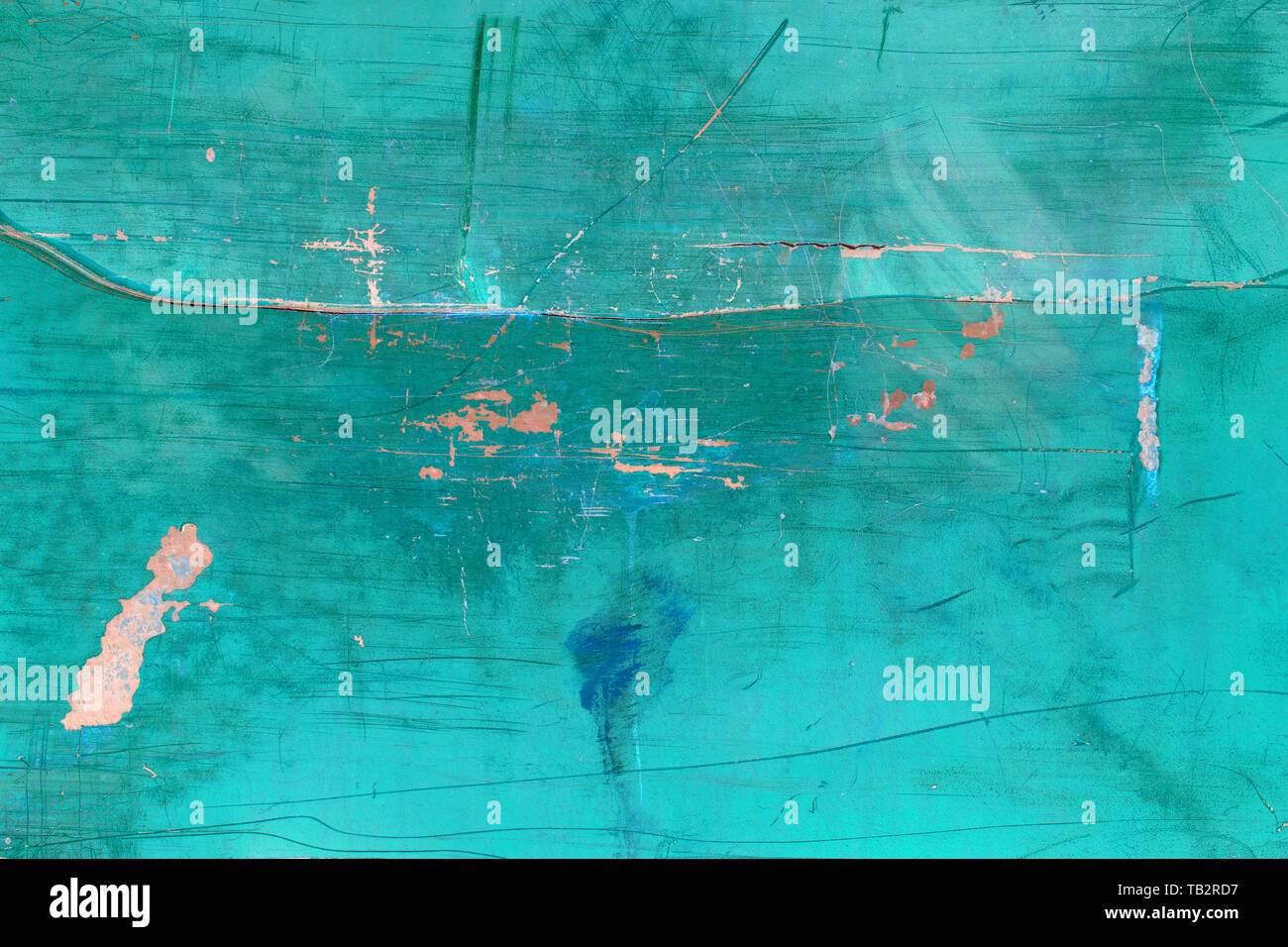 Inverted image of scratch marks and peeling blue paint on metal wall