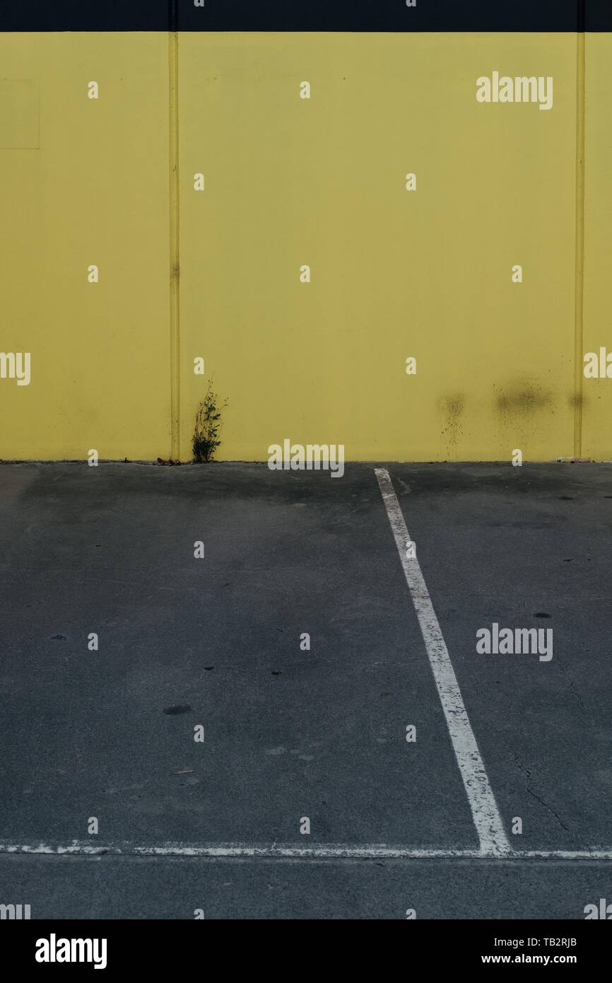 Outdoor parking lot with yellow walls Stock Photo Alamy