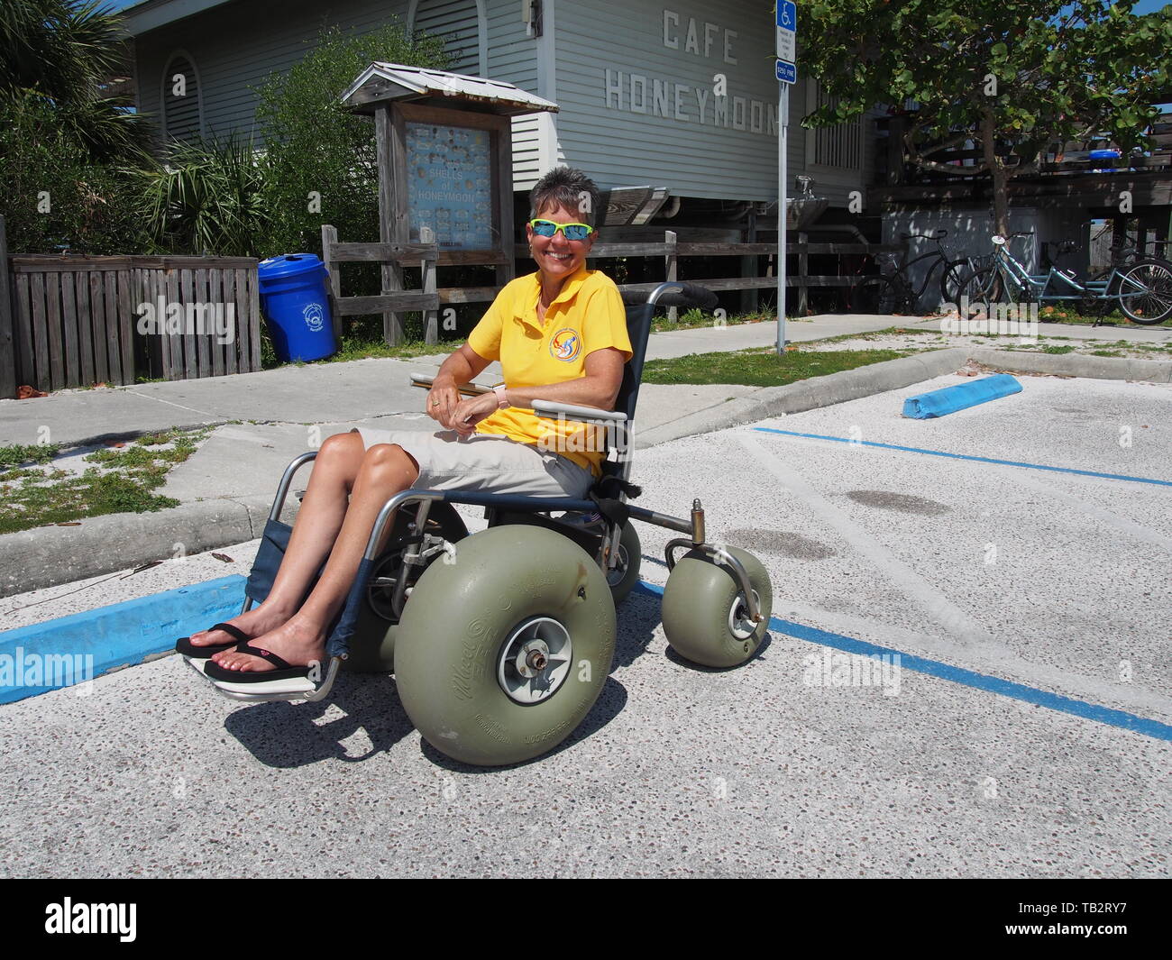 Disabled woman in beach wheelchair at Honeymoon Island State Park in Dunedin, Florida, USA, May
