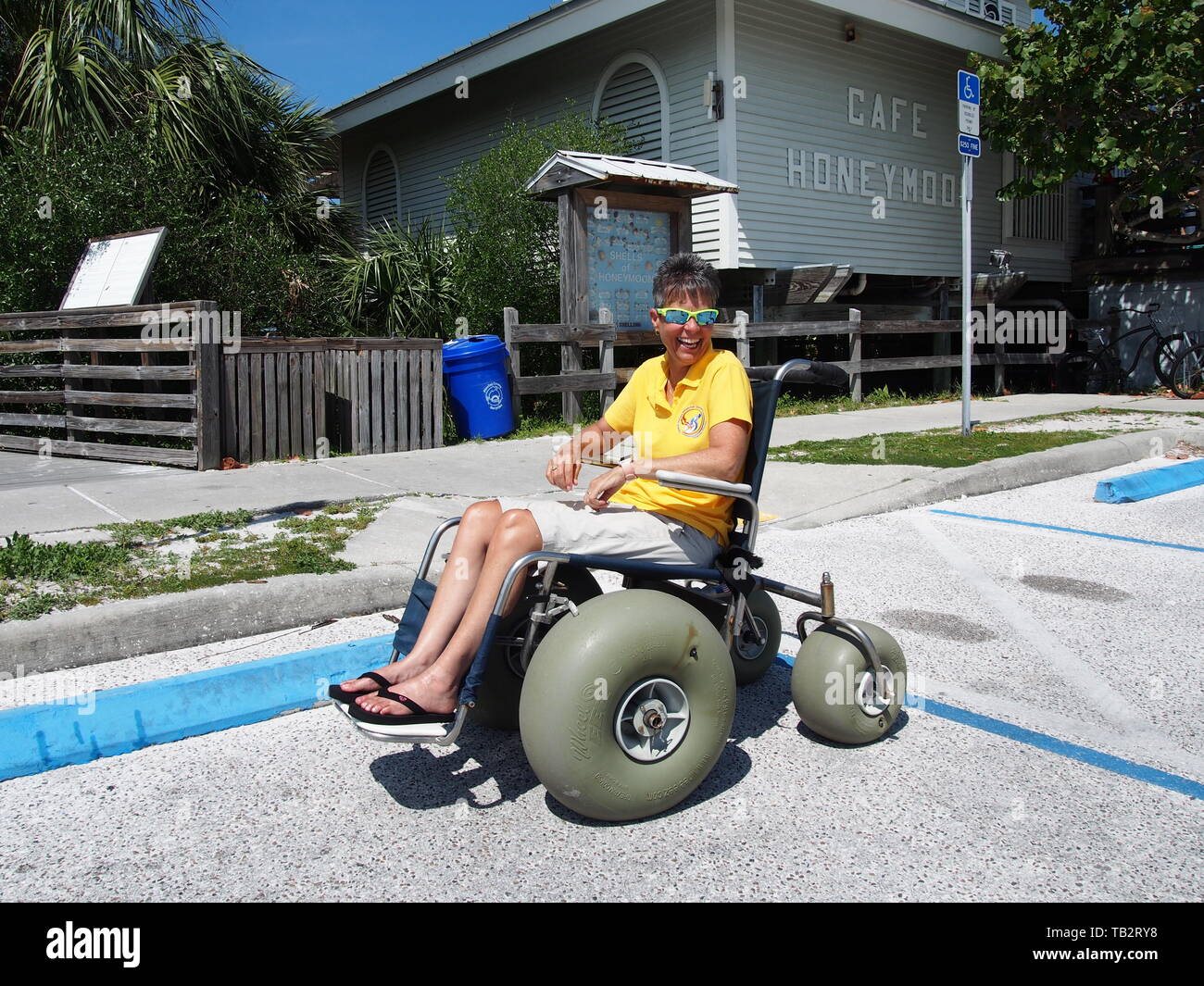 Disabled woman in beach wheelchair at Honeymoon Island State Park in Dunedin, Florida, USA, May