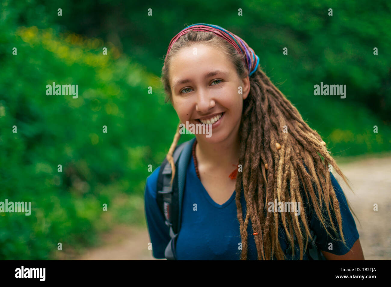 Portrait Of A Young Smiling Girl In The Forest Hairstyle