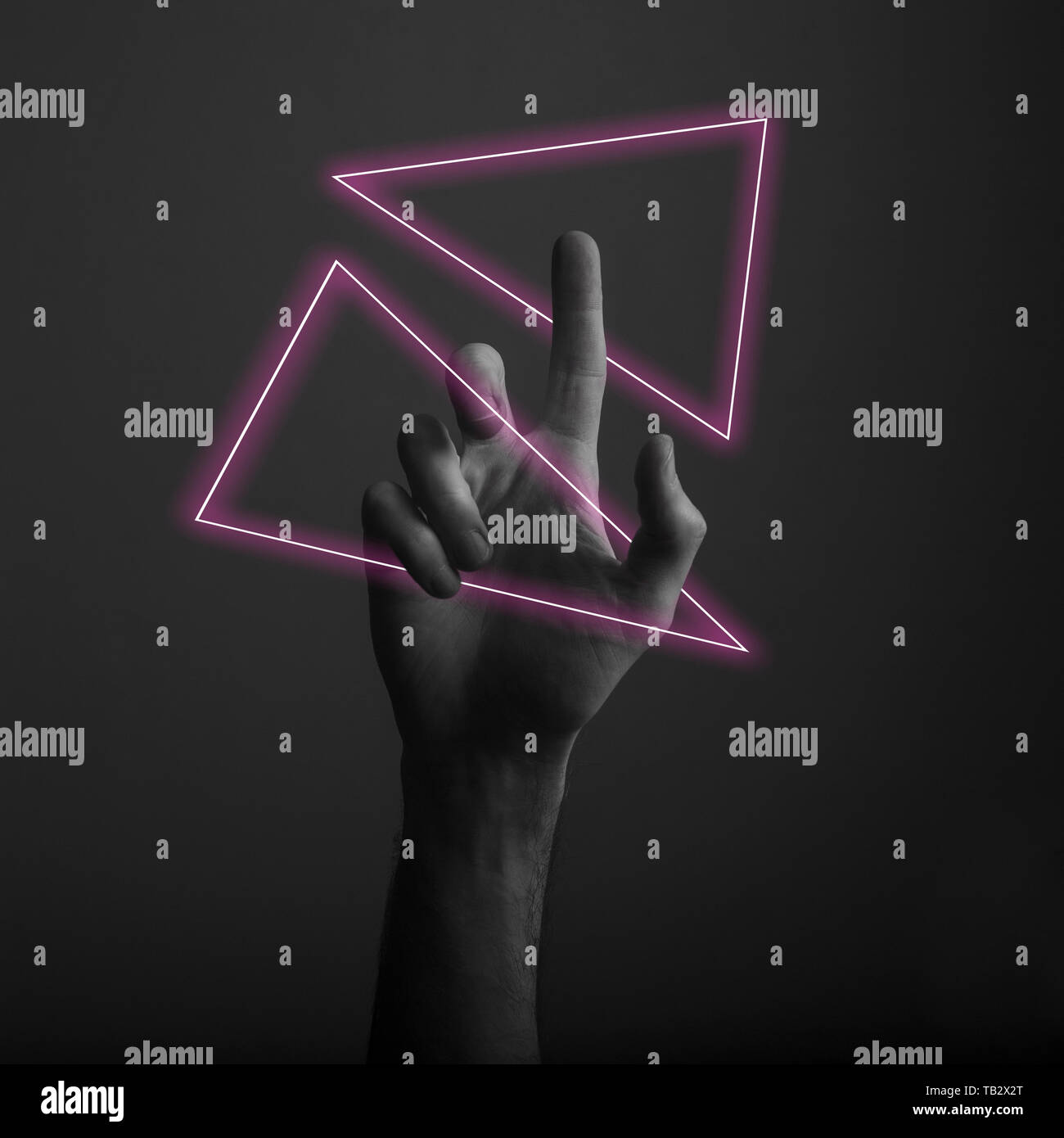 Hand pointing a finger against a dark background with abstract neon ...