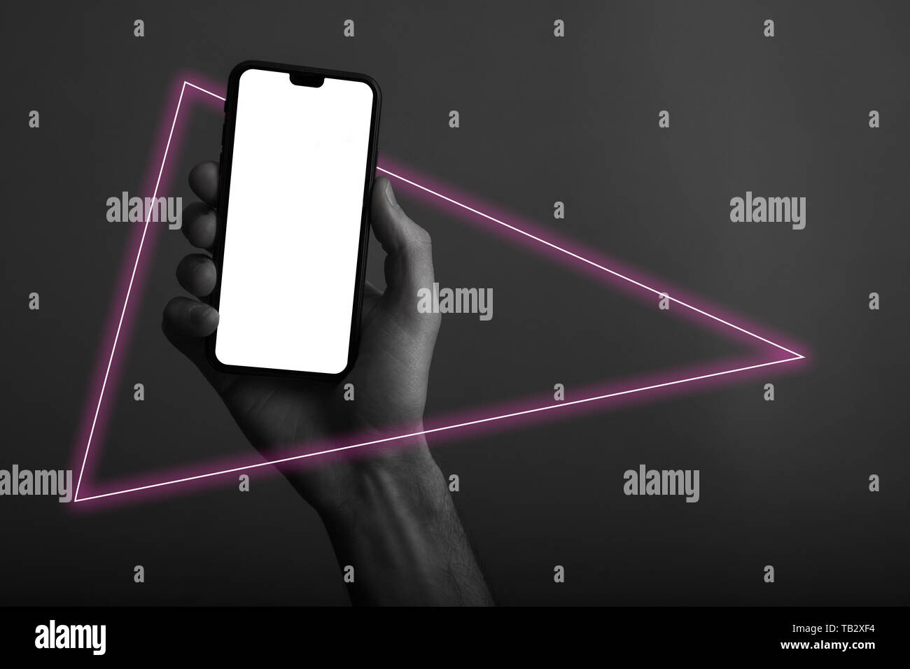 Hand holding modern smartphone with a blank white screen and neon light ...
