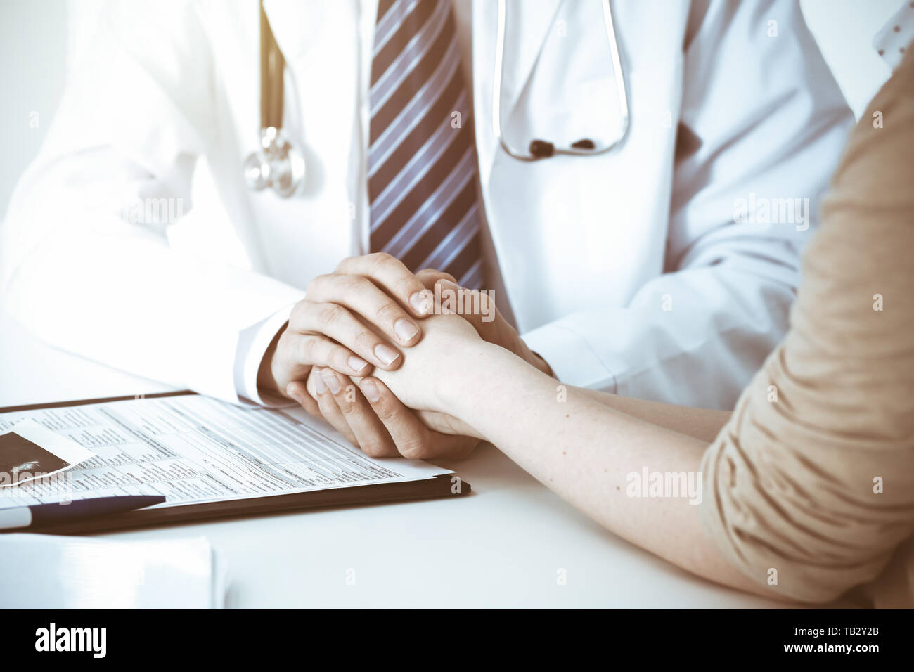 Trusting A Doctor Hand of doctor reassuring her female patient. Concepts of medical ...