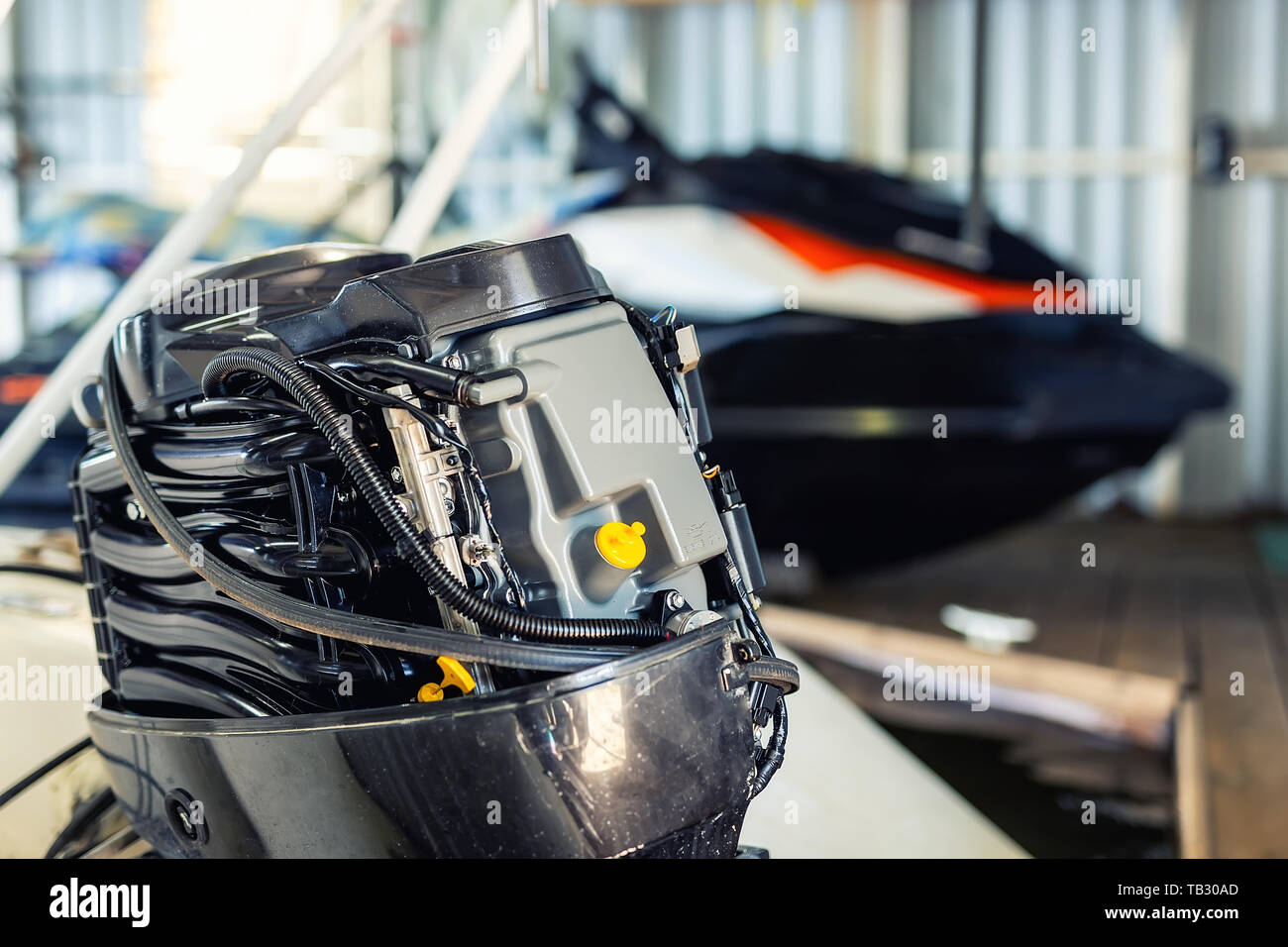 Repairing inflatable motorboat engine at boat garage. Ship engine