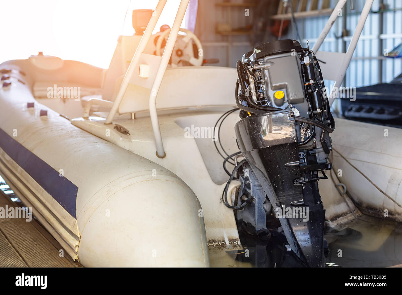 Repairing inflatable motorboat engine at boat garage. Ship engine