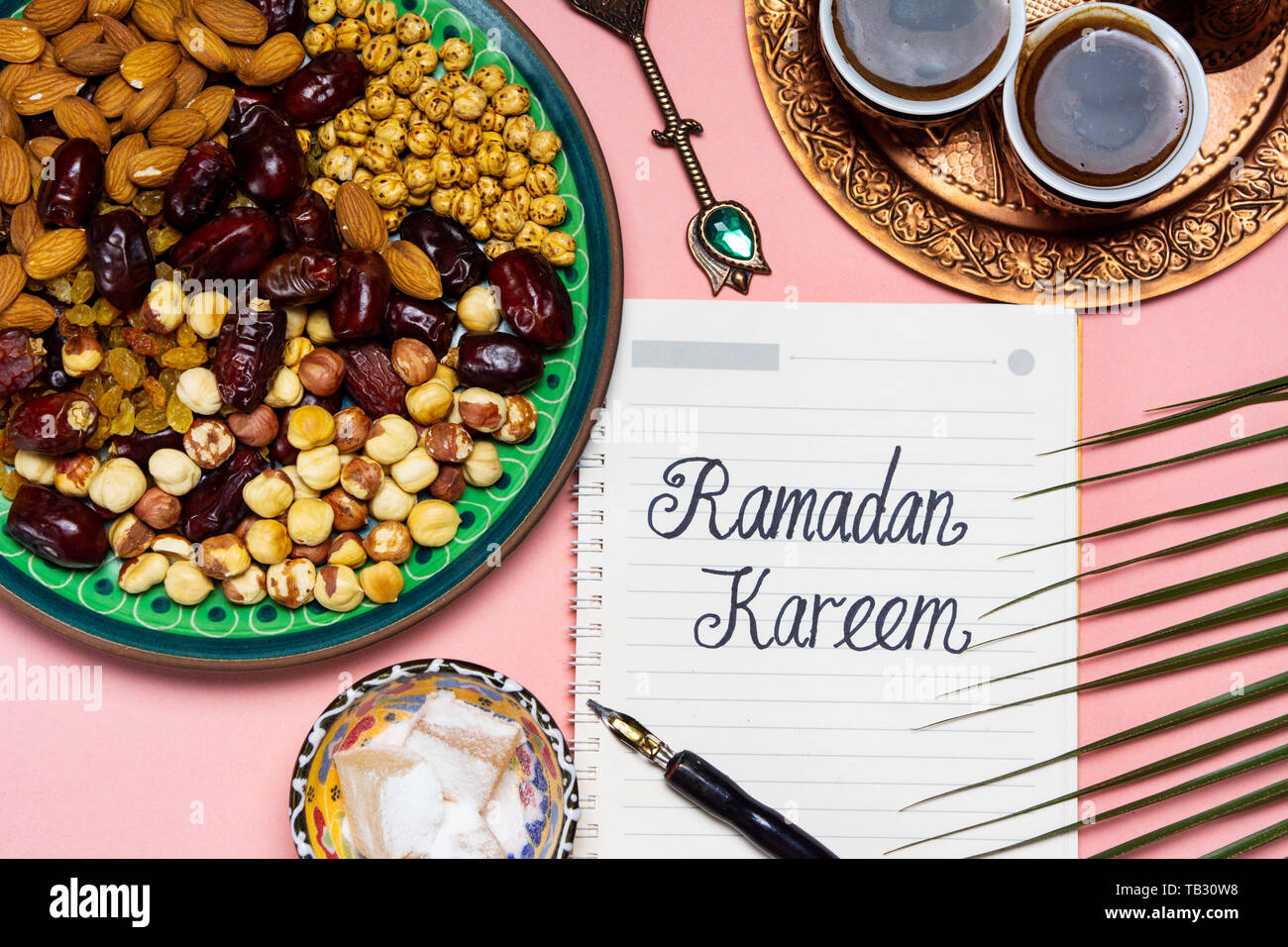 Ramadan Kareem note with snacks and coffee on a table Stock Photo