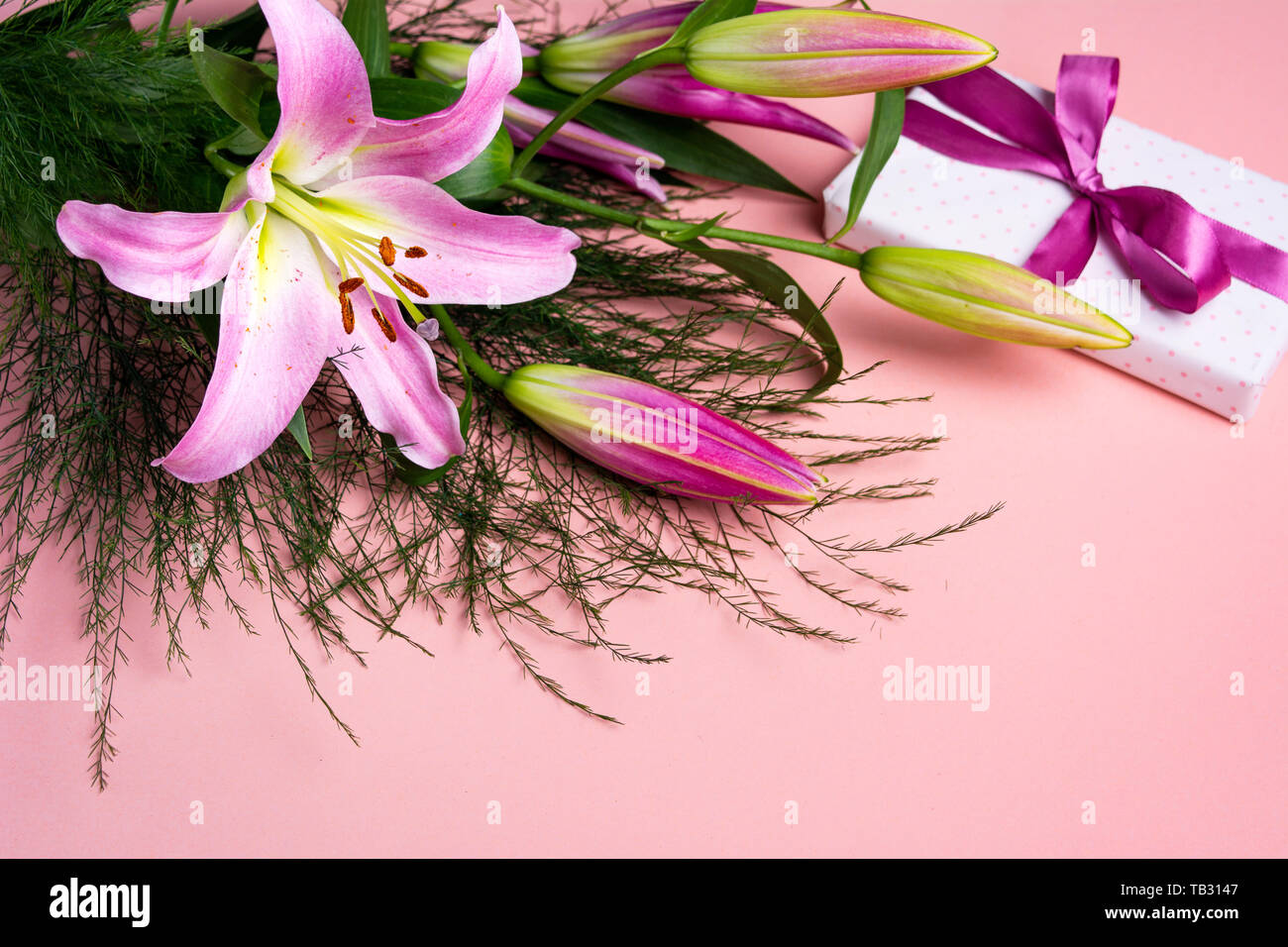 Beautiful Lily flowers bouquet on pink background Stock Photo