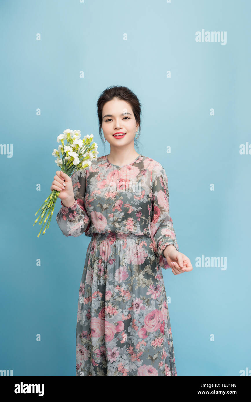 Portrait of a beautiful young woman in blue background Stock Photo - Alamy