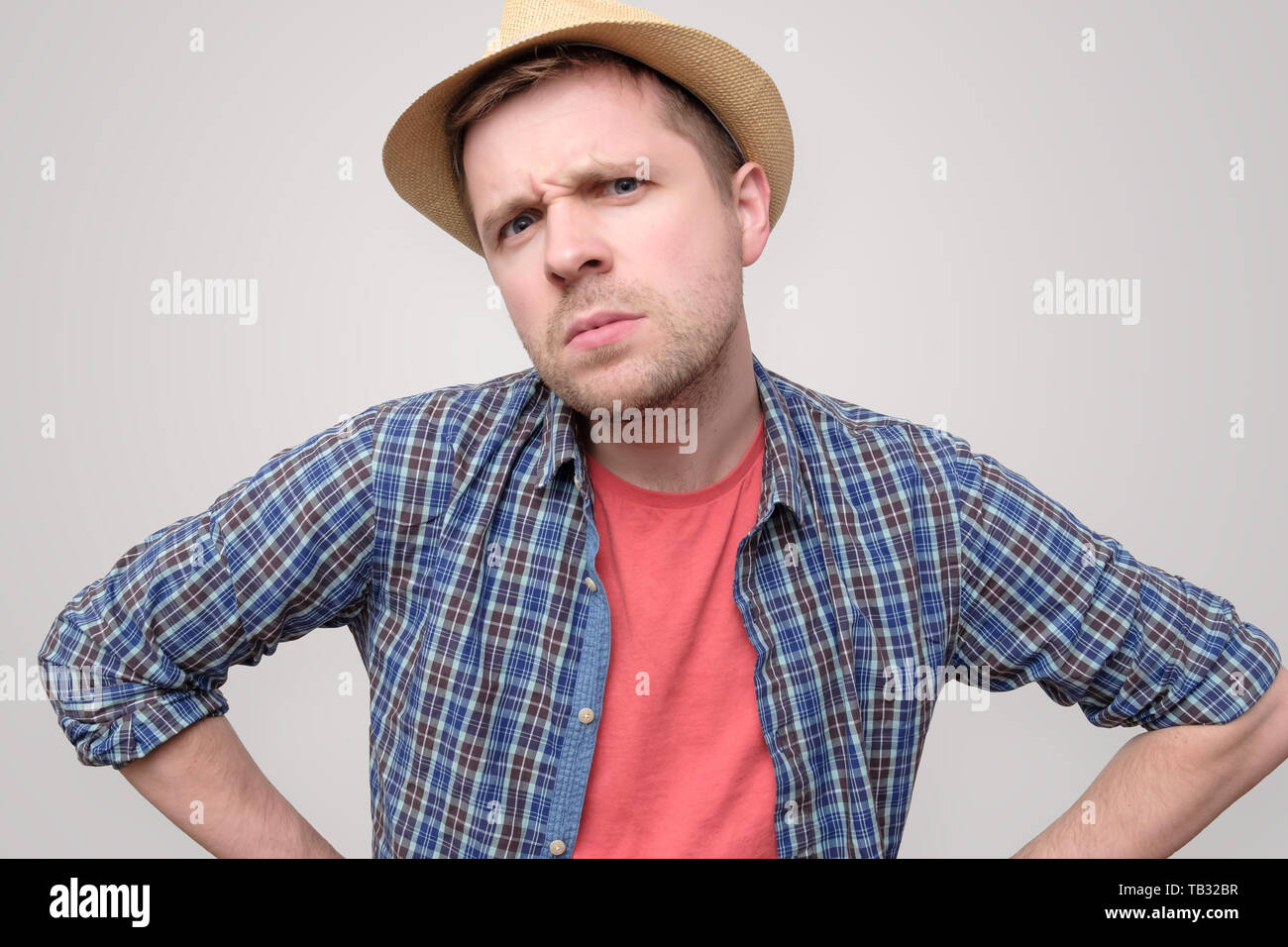 man in summer hat frowning being angry. Stock Photo