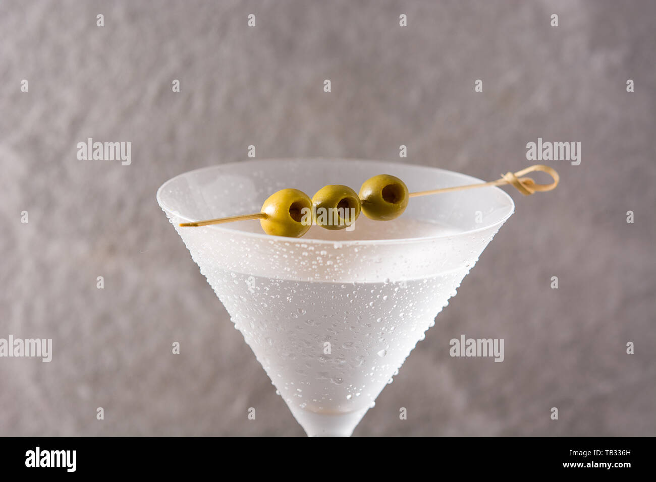 Classic Dry Martini with olives on gray background Stock Photo Alamy