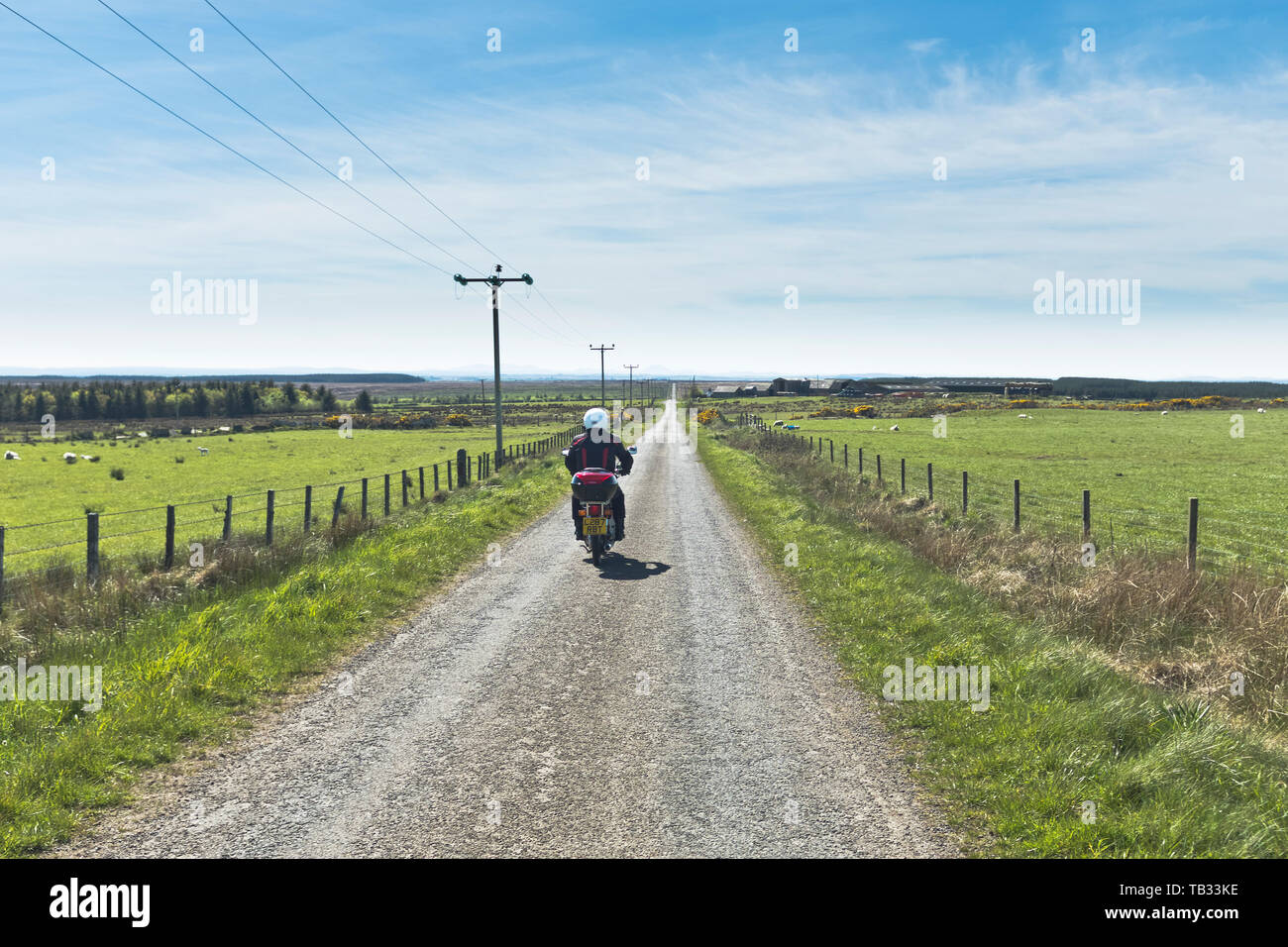 dh Honda C90 motorbike BRABSTER CAITHNESS Travelling on straight country open road Scotland motorcycle touring uk motorcycles Stock Photo