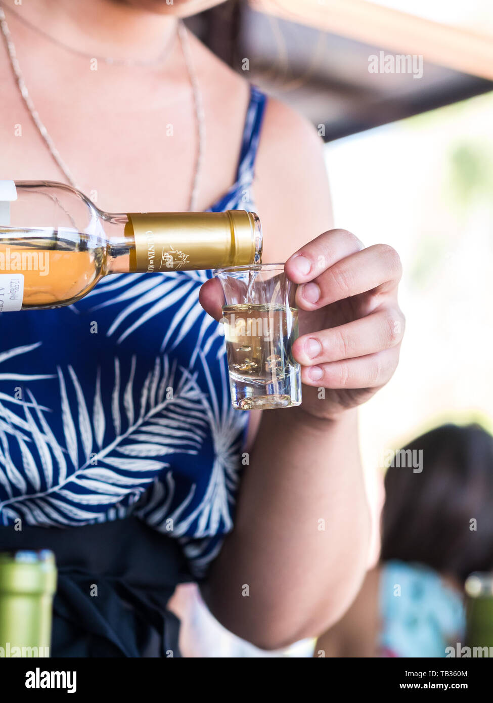 SETUBAL, PORTUGAL – AUGUST 25, 2018: Young woman presenting pouring moscatel wine during wine tasting in Quinta de Alcube in Setubal region, Portugal. Stock Photo