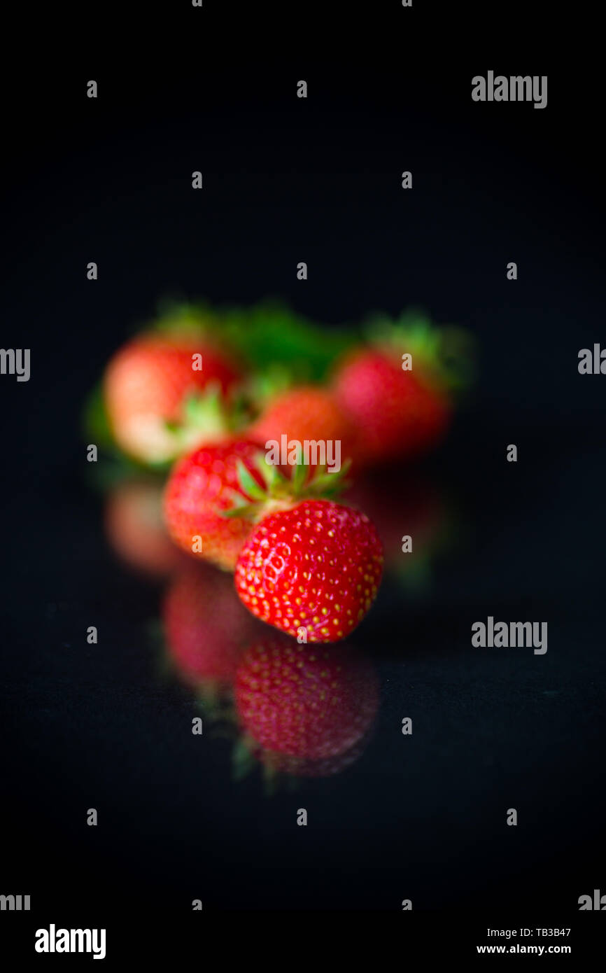 ripe red strawberries on a black background Stock Photo