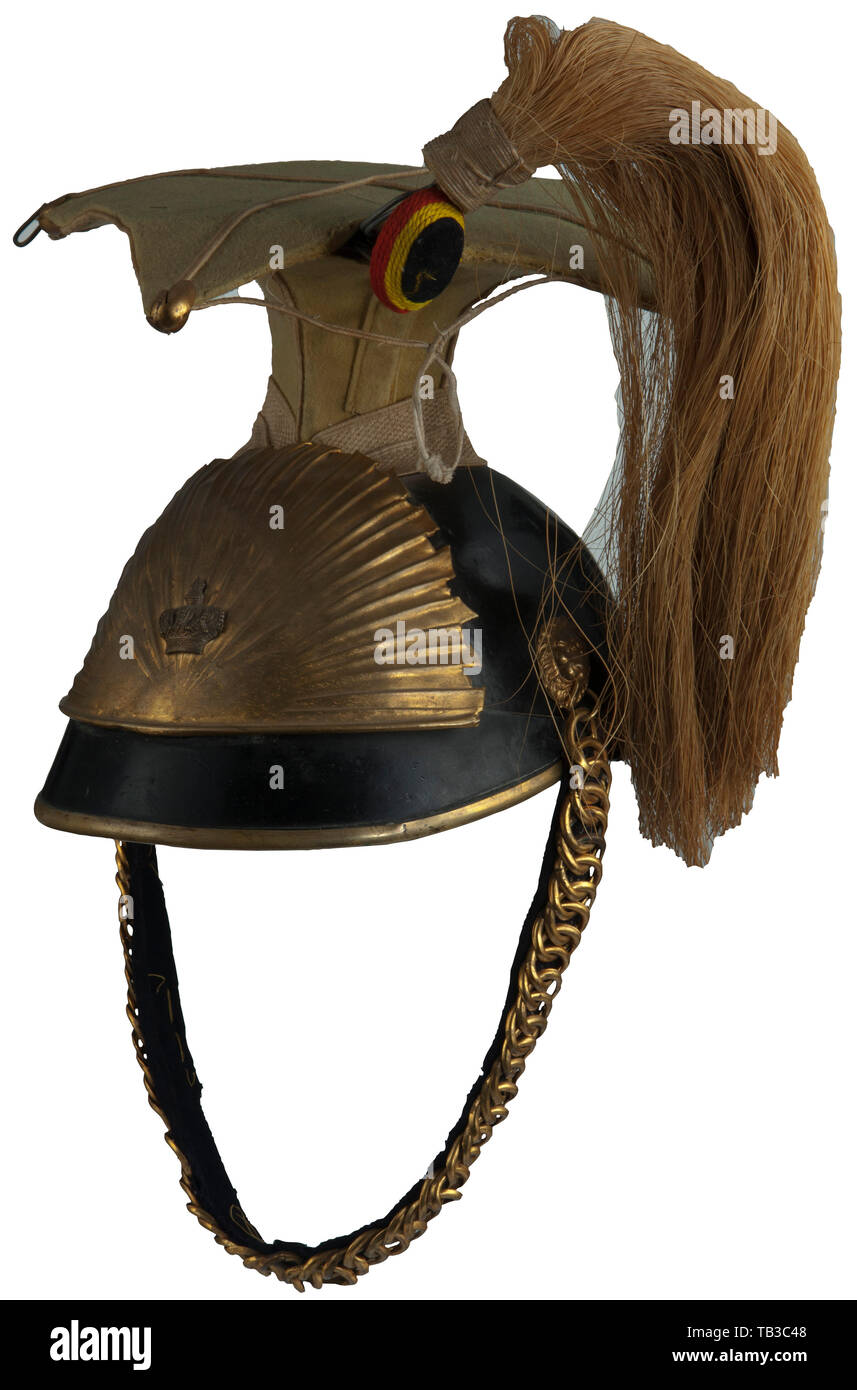A Belgium Napoleonic Uhlan czapka for enlisted men, Black leather body and front visor, yellow built-in rabatte with white piping, white double band around top of body, gold sun burst with crown front plate attached by two loops and leather strips, velvet lined gold chinstraps with lion head side posts, replacement tan leather sweatband with aged white cloth liner, white horse hair bush, black-yellow-red braid field badge, visor loose, enlarged hole for field badge. USA-lot. Belgium, historic, historical 19th century, Additional-Rights-Clearance-Info-Not-Available Stock Photo